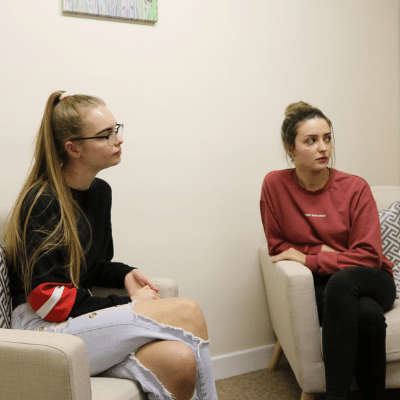 How we talk about mental health difficulties Two people sitting on chairs in a waiting area