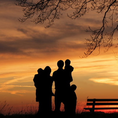 family-managing-anxiety Shadows of a family of five looking out into a sunset