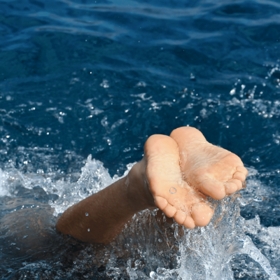 Feet showing diving into water