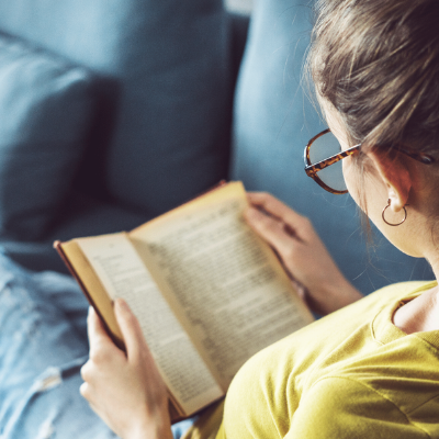 Girl with glasses reading to illustrate relaxation for mental health