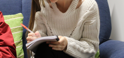 Information Close up of a young girl writing in a notebook