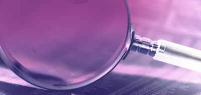 Information Magnified glass on a pink background
