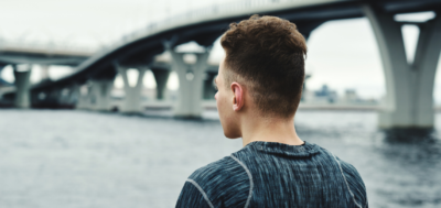 Information A young man looking into the distance with his airpods in