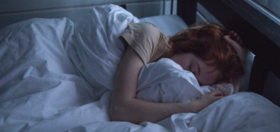 Information Young woman sleeping in her bed