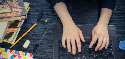 Information person taking notes on a laptop