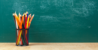 pencilsthumb coloured pencils in front of blackboard