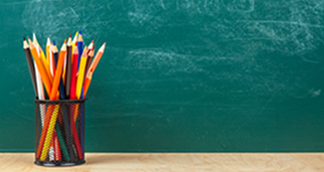 schoolsthumb coloured pencils in front of blackboard