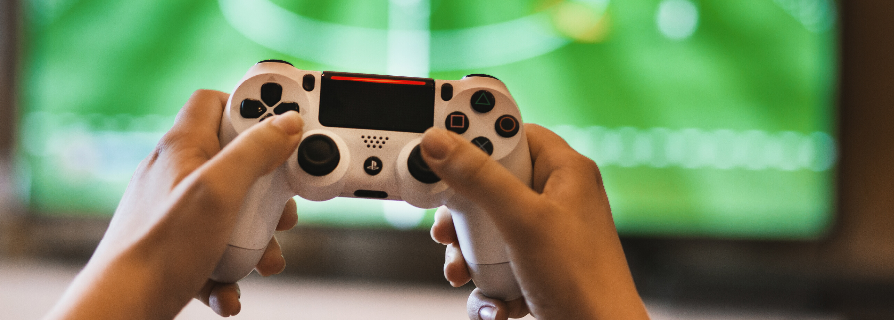 Image of hands holding a gaming console
