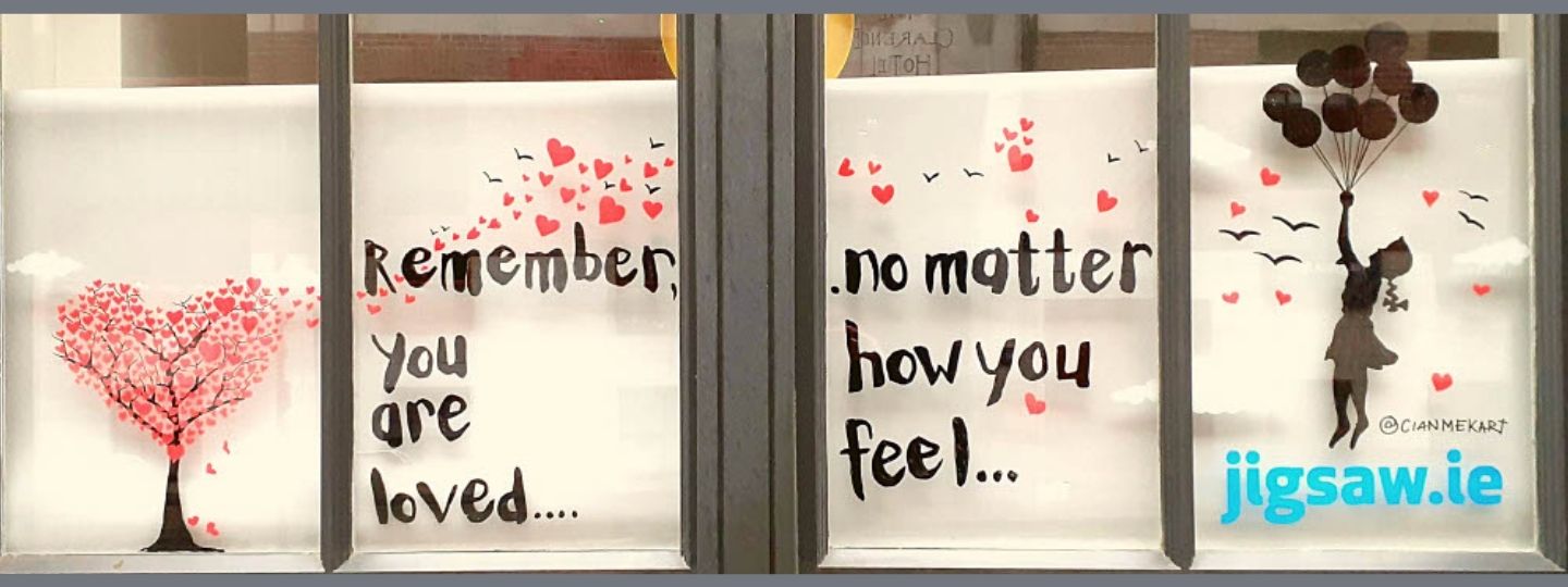 Banner image of a window display sharing positive messages for February