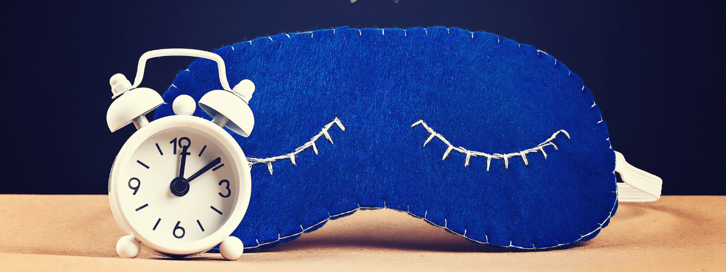A image of a alarm clock and a sleep mask