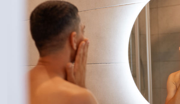 man looking in the mirror over his shoulder