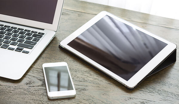 Image of laptop, ipad and mobile phone on desktop