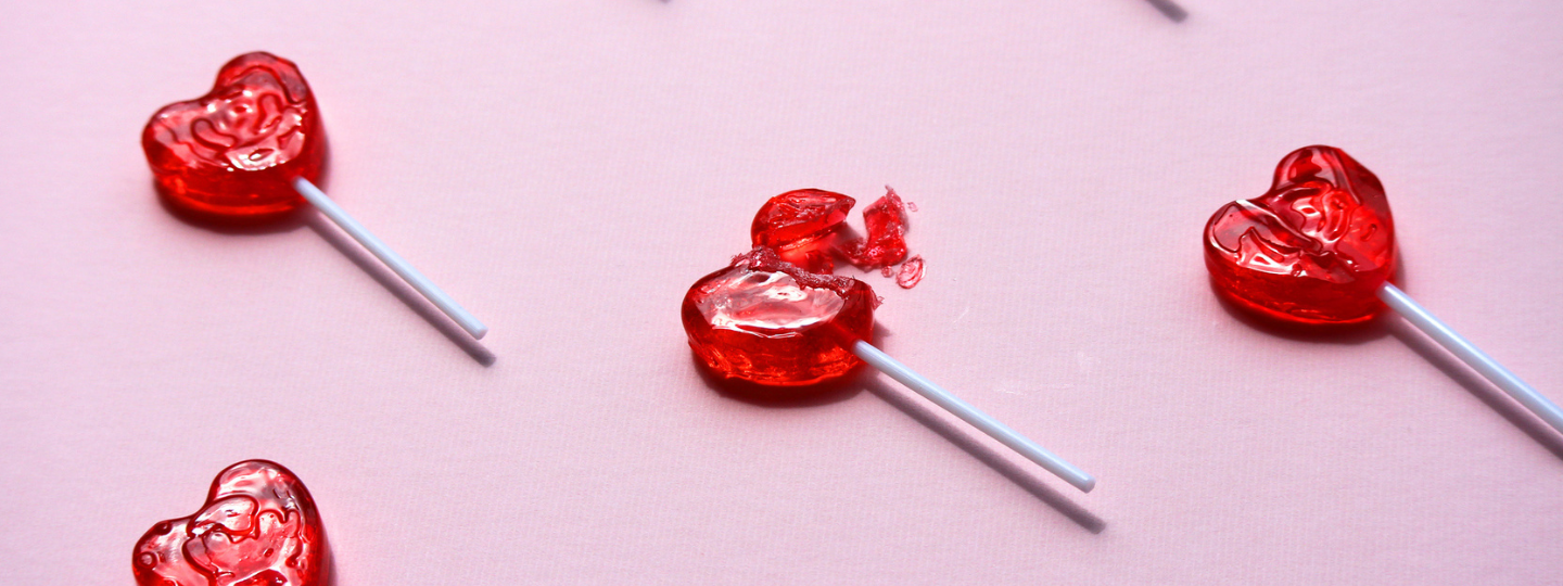 rows of red heart-shaped lolipops, which one smashed.